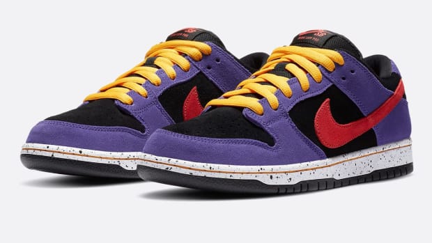 Purple, black, red, and yellow Nike Dunk shoes.