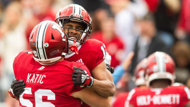 Indiana's Jaylin Lucas (12) celebrates with Mike Katic (56) after Lucas' touchdown during the first half of the Indiana versus Purdue football game at Memorial Stadium on Saturday, Nov. 26, 2022.