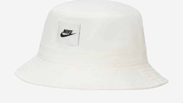 View of white and black Nike bucket hat.