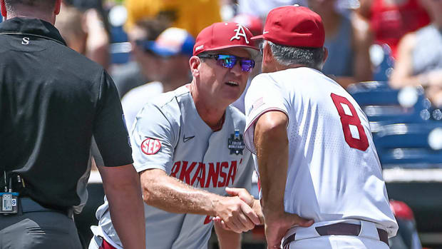 Arkansas coach Dave Van Horn and Stanford coach Dave Esquer meet at home plate prior to their game in the first round of the College World Series in Omaha, Neb.