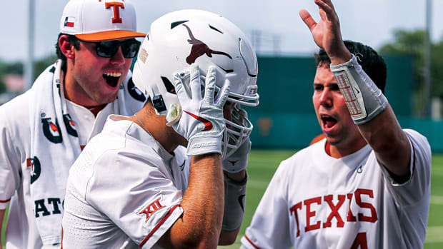 Texas infielder Mitchell Daly (19) puts on a Texas football helmet to celebrate a home run against Kansas at Disch-Falk Field in Austin, Texas on May 21.