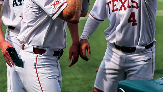 Texas infielder Mitchell Daly (19) puts on a Texas football helmet to celebrate a home run against Kansas at Disch-Falk Field in Austin, Texas on May 21.