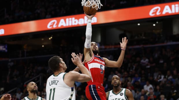 Washington Wizards guard Tyus Jones (5) shoots the ball over Milwaukee Bucks center Brook Lopez (11) in the first quarter at Capital One Arena.