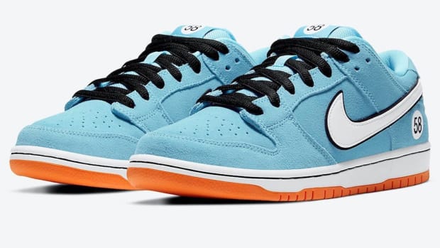 View of blue, white, and orange Nike Dunk shoes.