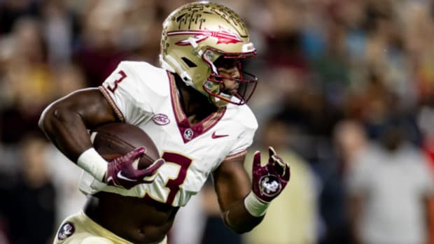 Florida State Seminoles running back Trey Benson on a rushing attempt during a college football game in the ACC.