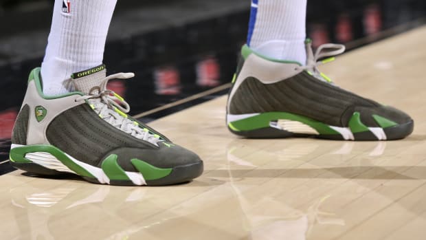View of grey and green Air Jordan shoes.