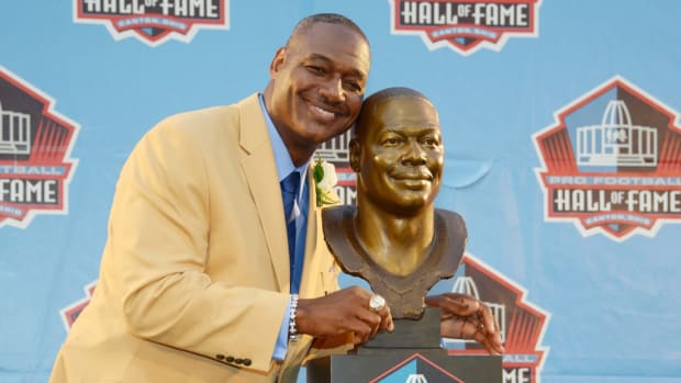 Derrick Brooks poses with his bust at the 2014 Pro Football Hall of Fame Enshrinement at Fawcett Stadium.