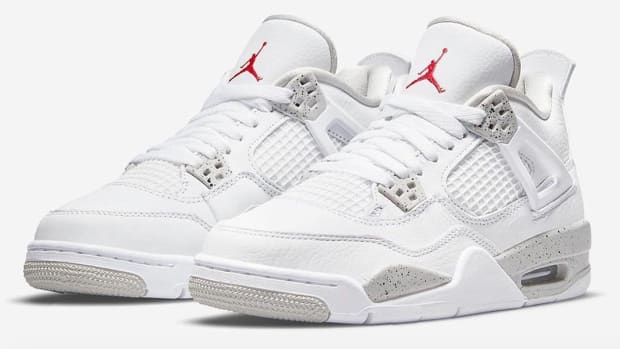 View of white and grey Air Jordan 4 shoes.