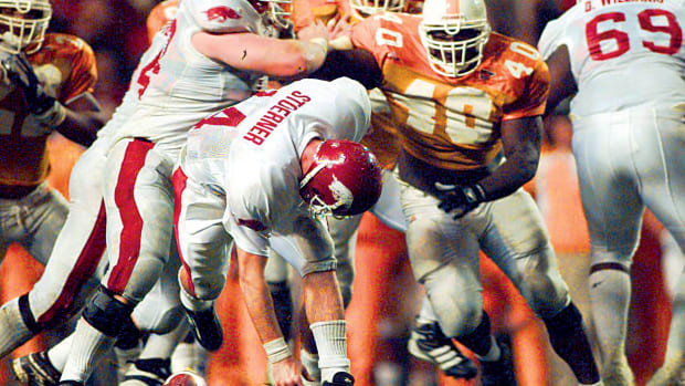 Arkansas' Clint Stoerner fumbles the ball in the closing minutes of play against Tennessee on Nov. 14, 1998, turning the ball over in Knoxville. The Vols' Billy Ratliff (40) recovered and Tennessee won the game 28-24. The play preserved Tennessee's undefeated season and they went on to win the national championship.