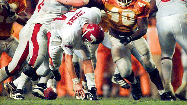 Arkansas' Clint Stoerner fumbles the ball in the closing minutes of play against Tennessee on Nov. 14, 1998, turning the ball over in Knoxville. The Vols' Billy Ratliff (40) recovered and Tennessee won the game 28-24. The play preserved Tennessee's undefeated season and they went on to win the national championship.