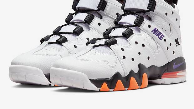 White, black, and orange Nike 'CB' shoes.