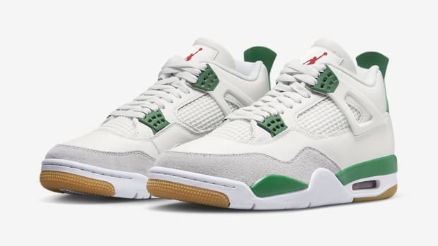 Side view of white and green Air Jordan sneakers.