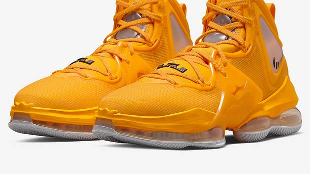 Side view of yellow and black Nike LeBron shoes.