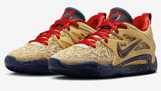 View of gold, navy, and red Nike KD shoes.