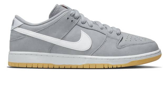 Side view of grey and white Nike Dunk shoes.