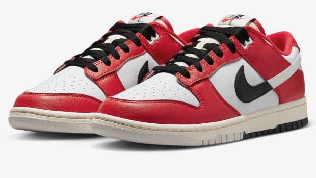 Side view of red, white, and black Nike Dunk sneakers.