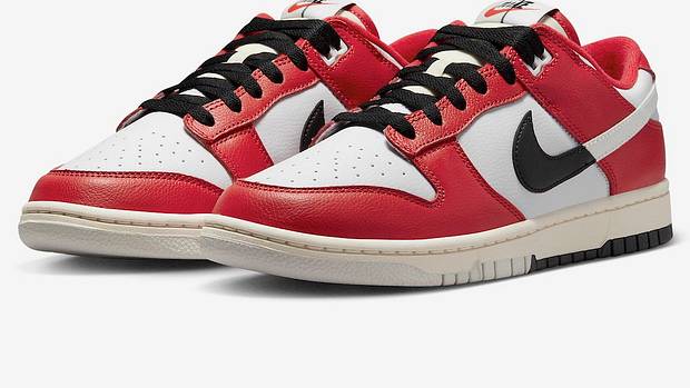 Side view of red, white, and black Nike Dunk sneakers.