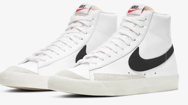 Side view of white and black Nike sneakers.