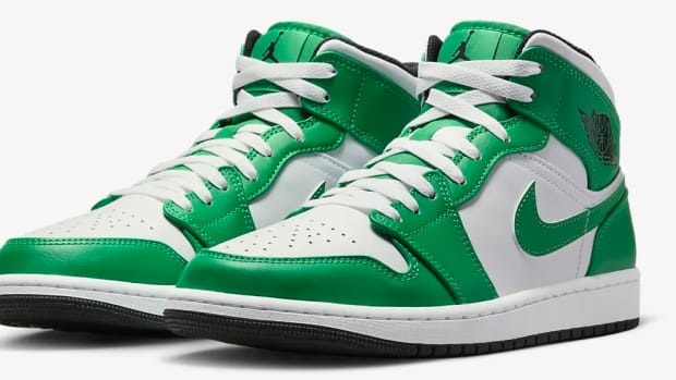 Side view of green and white Air Jordan sneakers.