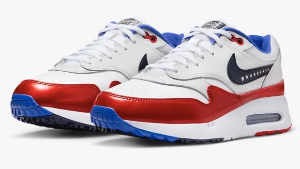 Side view of red, white, and blue Nike Air Max golf shoes.