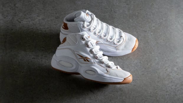 Side view of Allen Iverson's white and brown Reebok sneakers.