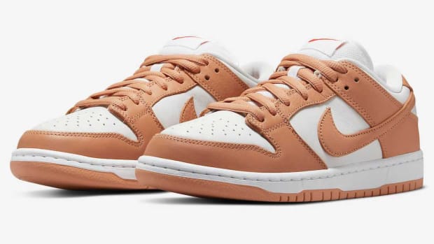 Tan and white Nike Dunk shoes.