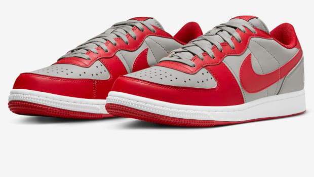 Side view of scarlet and grey Nike sneakers.