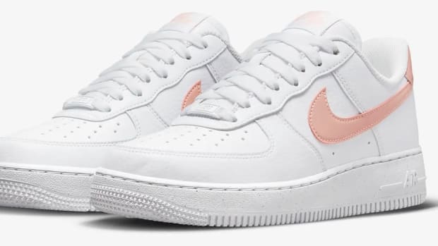 View of white and pink Nike shoes.