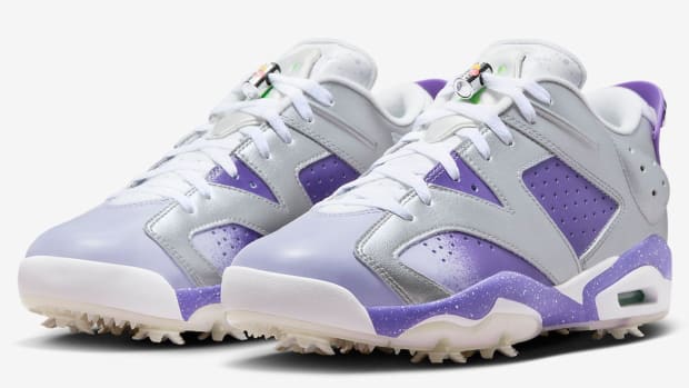 Side view of purple and grey Air Jordan golf shoes.