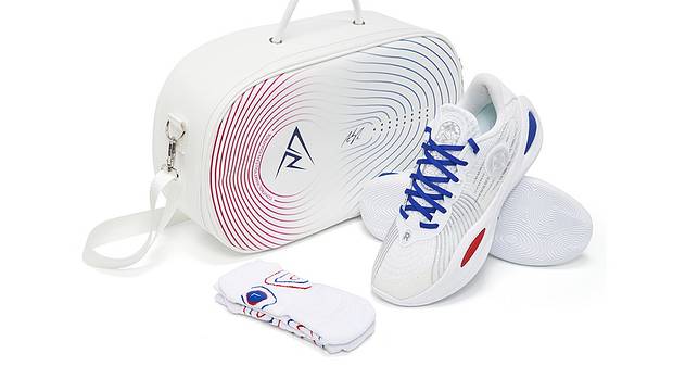 Side view of Austin Reaves' white, blue, and red sneakers.