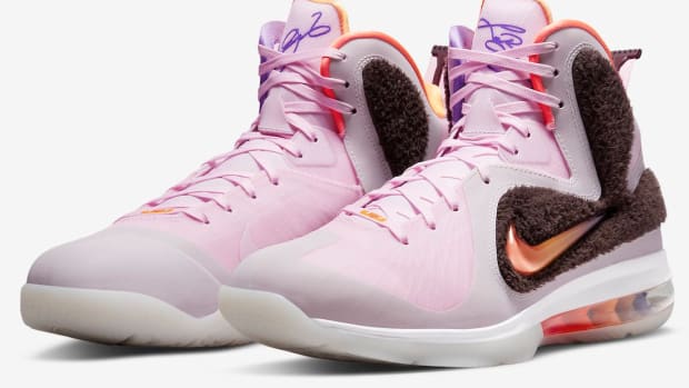 Side view of LeBron James' pink and orange Nike shoes.
