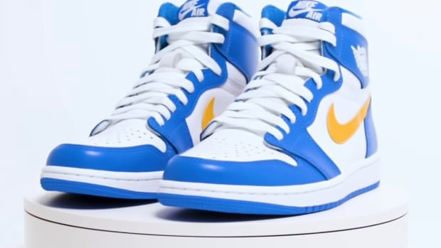 White, blue, and gold Air Jordan shoes.