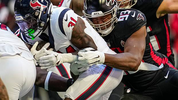 Atlanta Falcons defensive tackle Calais Campbell (93) tackles Houston Texans running back Dameon Pierce (31) during the first quarter at Mercedes-Benz Stadium.