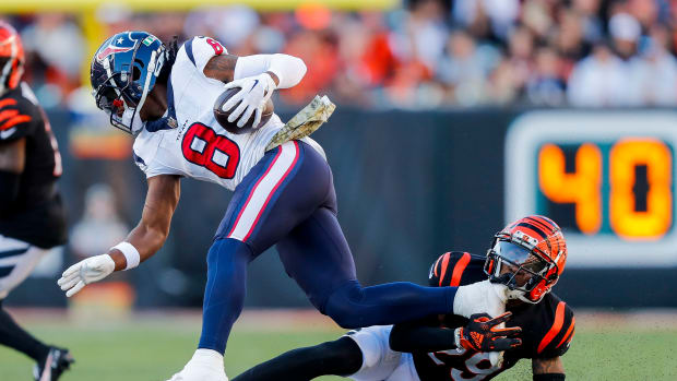 Texans wide receiver John Metchie III runs with the ball against Cincinnati Bengals cornerback Cam Taylor-Britt (29) in the second half at Paycor Stadium.