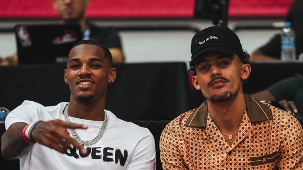Dejounte Murray sitting beside Trae Young.