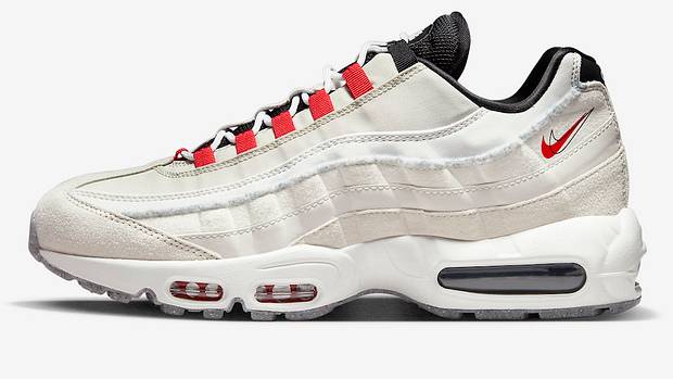 Side view of white and red Nike shoe.