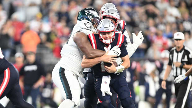 New England Patriots quarterback Mac Jones (10) is tackled by Philadelphia Eagles defensive tackle Jalen Carter (98) during the second half at Gillette Stadium.
