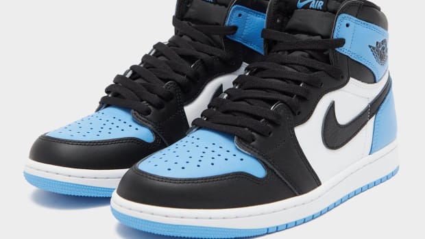 Side view of blue, black, and white Air Jordan sneakers.