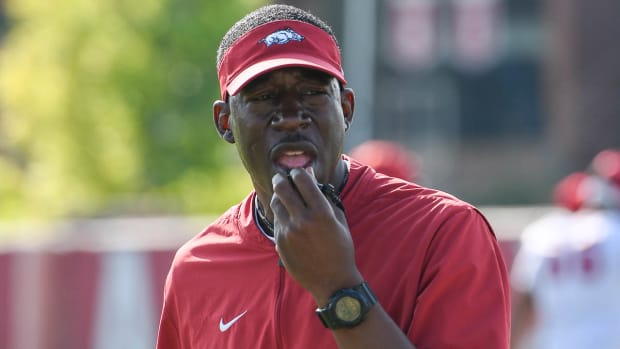 Razorbacks running backs coach Jimmy Smith during Friday morning's practice on the outdoor fields
