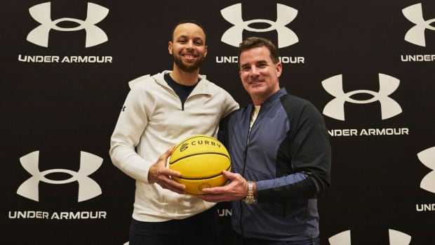 Stephen Curry poses for a photo with Kevin Plank.