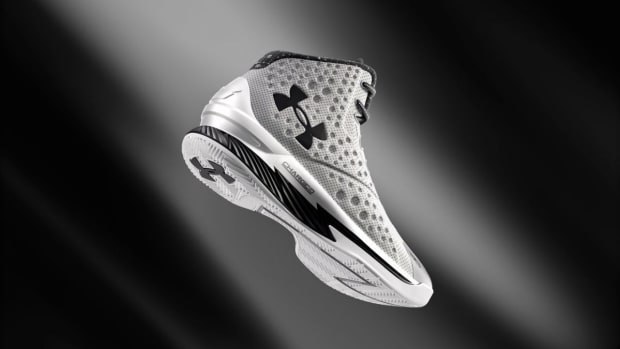 View of grey, black, and white Under Armour shoe.