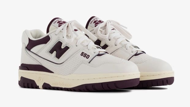 View of cream and maroon New Balance shoes.
