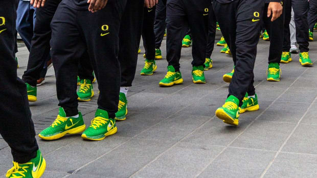 View of Oregon Ducks football players' green and yellow Nike shoes.