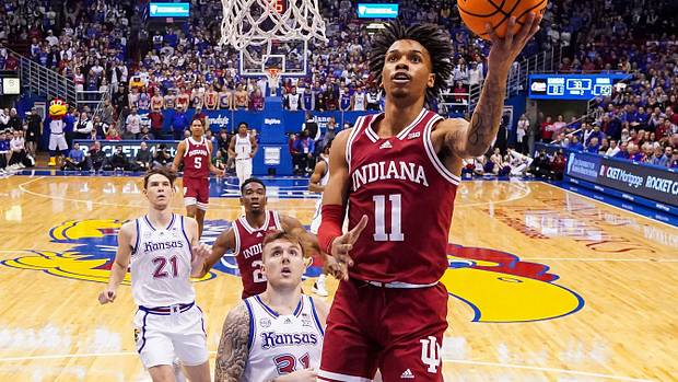 Indiana Hoosiers guard CJ Gunn (11) shoots a layup against Kansas Jayhawks forward Cam Martin (31) during the second half at Allen Fieldhouse.