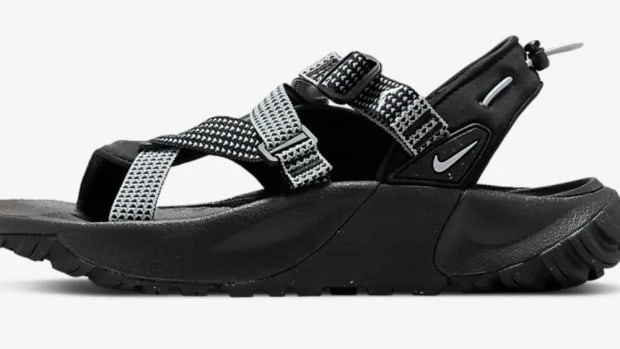 Side view of black Nike sandals.