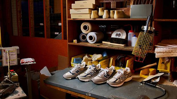 View of four grey New Balance sneakers in a workshop.