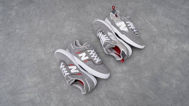 Side view of two grey New Balance shoes.
