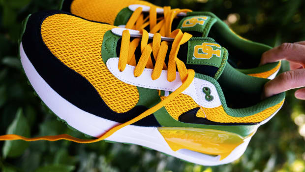 Side view of green, yellow, and black Nike sneakers.