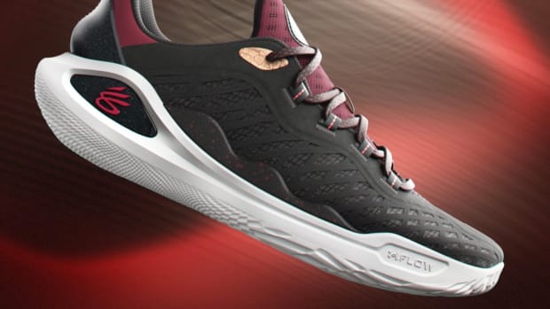 Side view of Stephen Curry's black, red, and white basketball shoes.