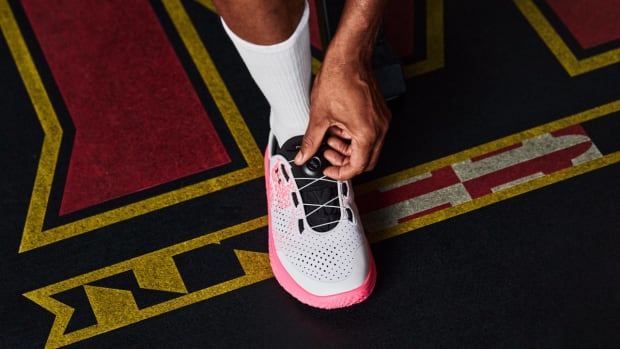 View of white and pink Under Armour shoe.